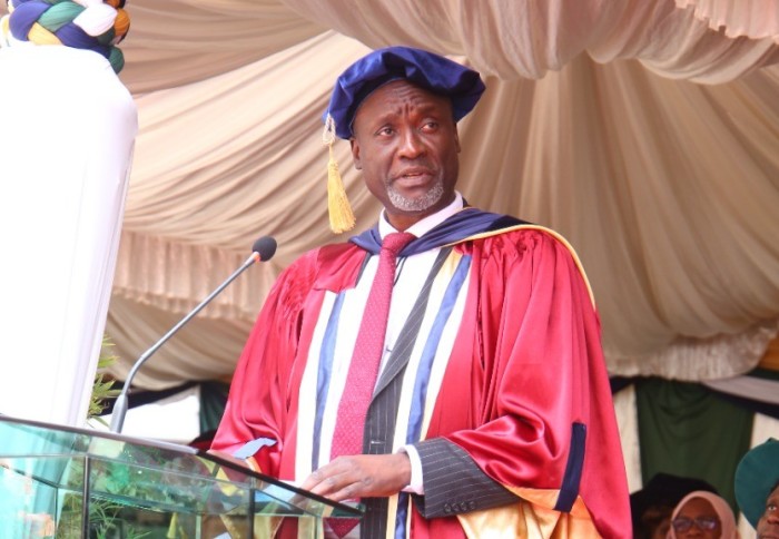 Professor Washington Ochieng giving his acceptance speech at the Technical University of Kenya, wearing red academic robes