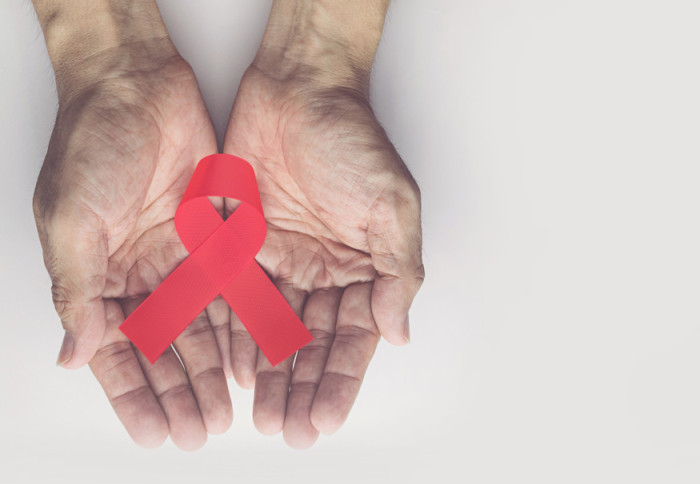 HIV / AIDS ribbon in hands