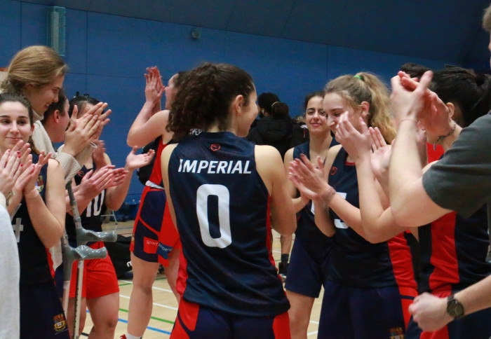 A group of Imperial Athletes applauding their teammate after a match in Ethos Sports Hall