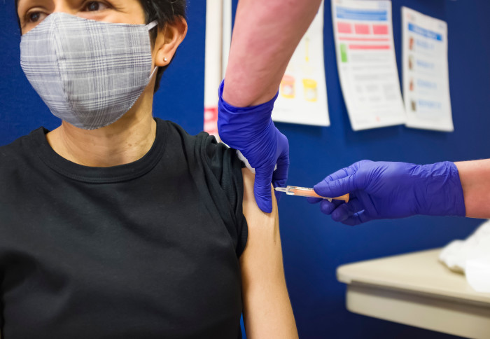 An adult receiving their COVID-19 vaccine