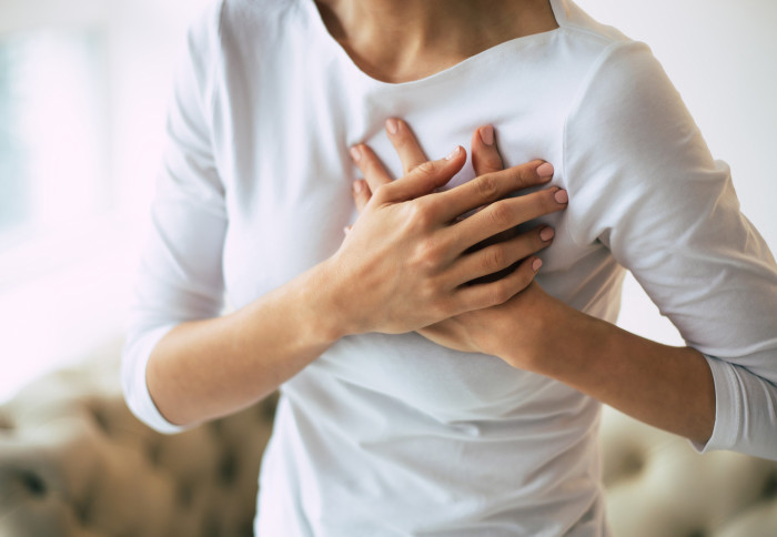 A woman experiencing severe chest pain.