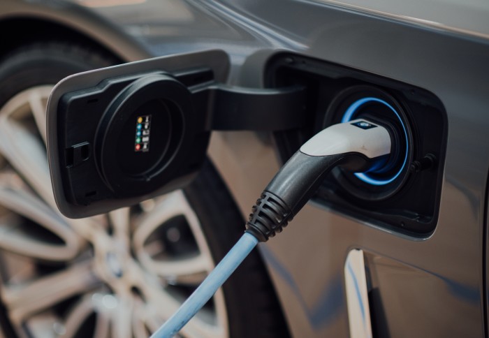 Electric car charger plugged into an electric car