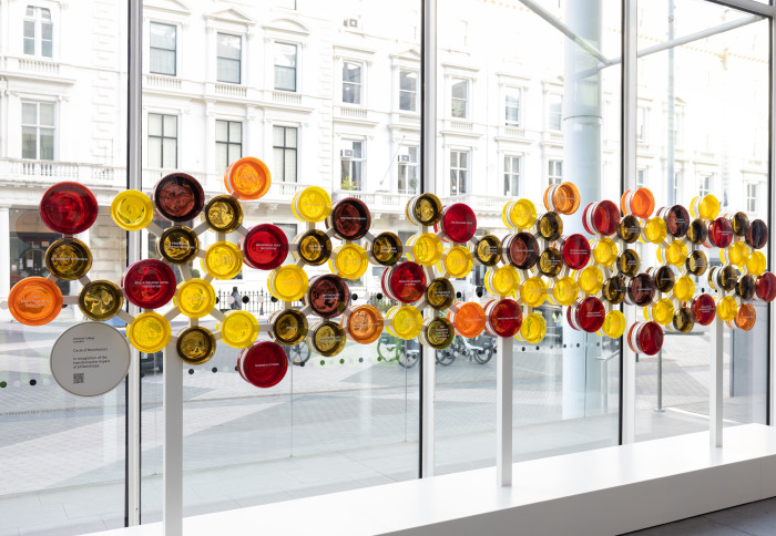 The donor installation installed in College Main Entrance. It comprises of circles of glass in warm colours bearing donors' names