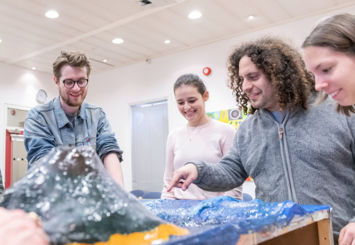 Students in the Department of Earth Science and Engineering study a model of volcanoes