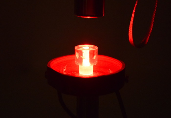 An image of a The 'DAP' maser crystal in its resonator illuminated with red light