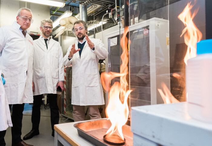 Three men in a fire lab