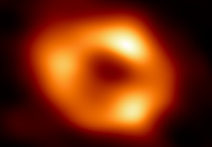 A fuzzy orange ring of light with a black centre