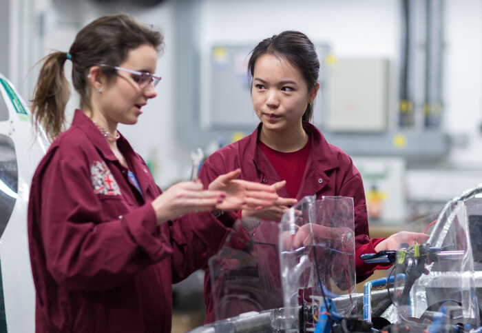 Two women Mechanical Engineering undergraduates in the Pit Garage working on building a vehicle.