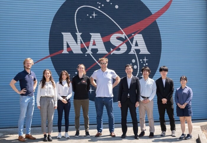 Students standing in front of NASA logo