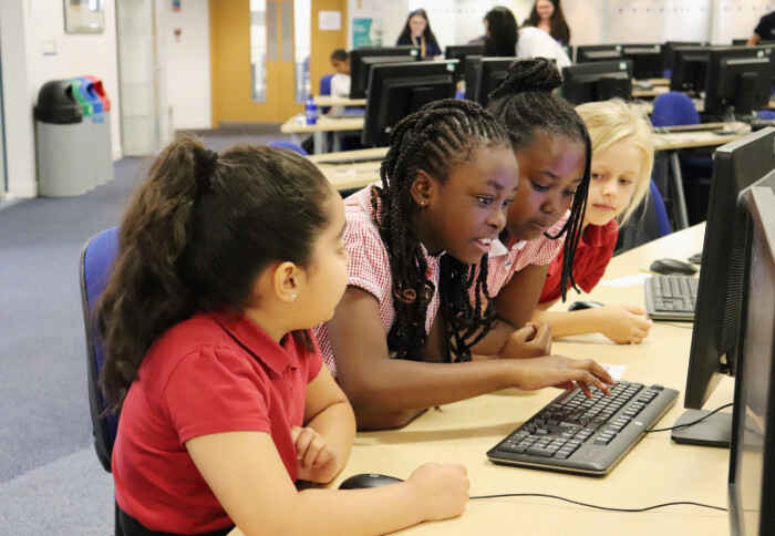 Girls engaging in computing activities as part of Hello World Hack