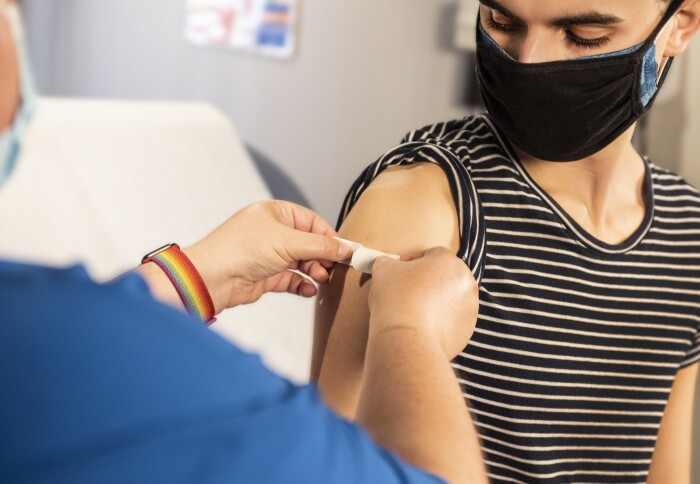 Image of a person being given a plaster after vaccination.