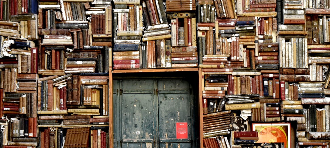 Old books stacked around an old doorframe