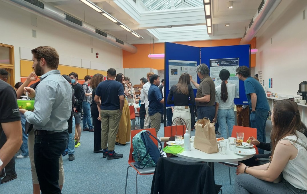 symposium attendees looking at research posters