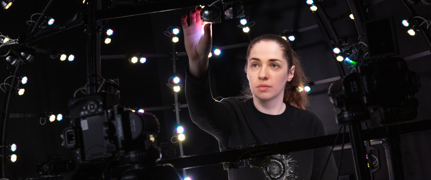 Woman reaches for a light above