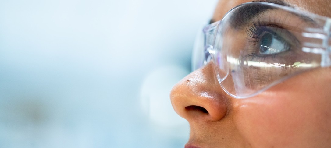 Close-up shot of a person in a pair of lab goggles