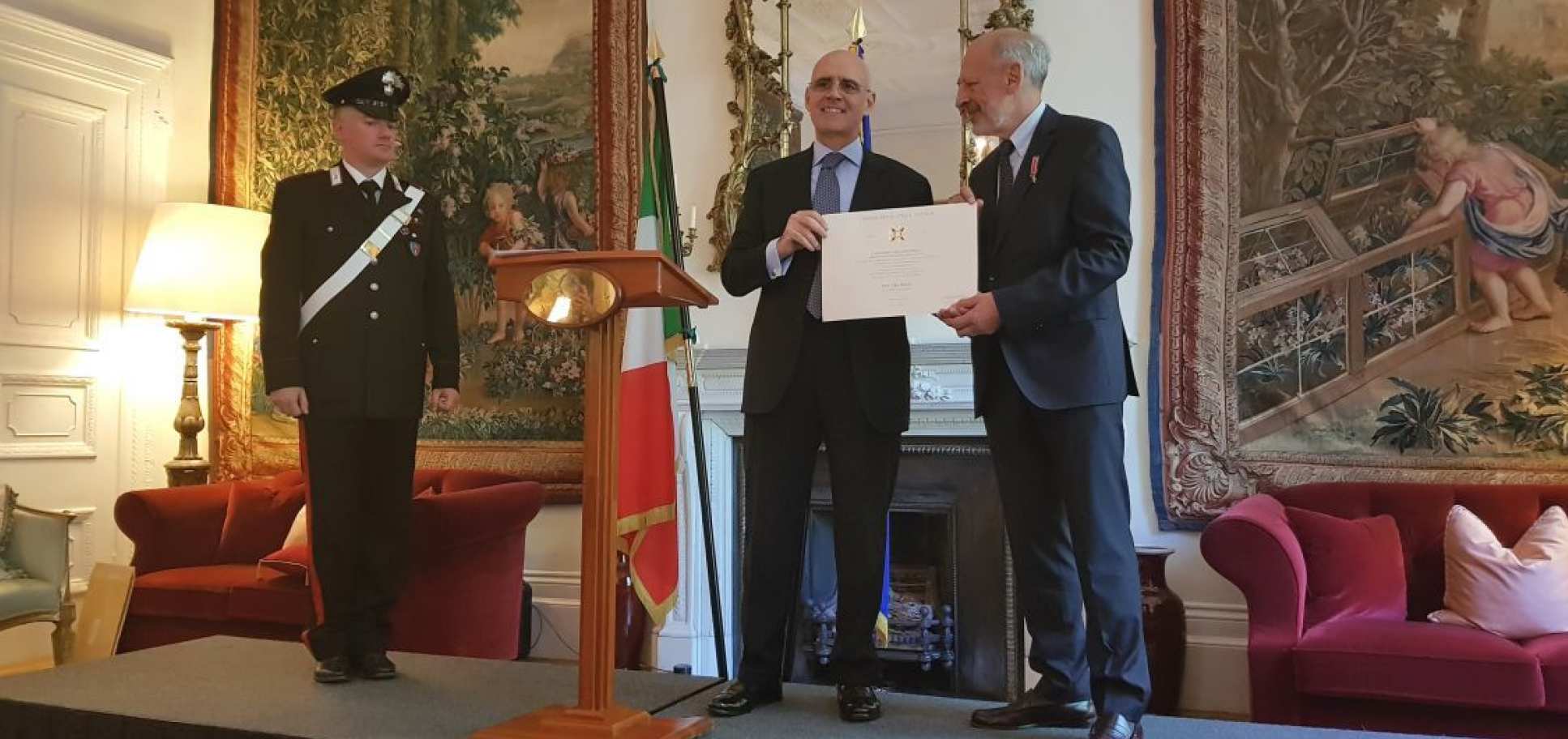 Professor Elio Riboli receiving his honour from the Italian Ambassador