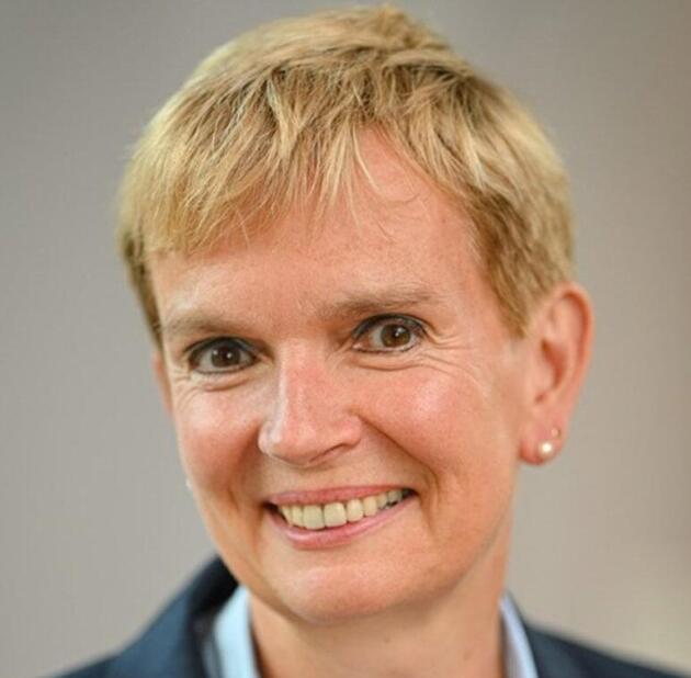 Head shot of a smiling woman with short blonde hair