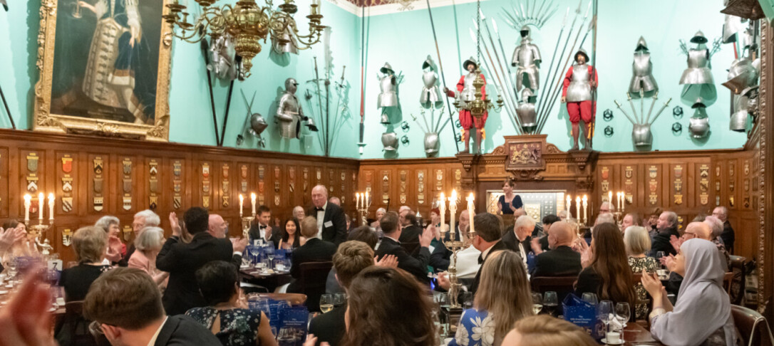 A photo of a full grand dining hall at the last dinner in 2024, which was also a black tie event 