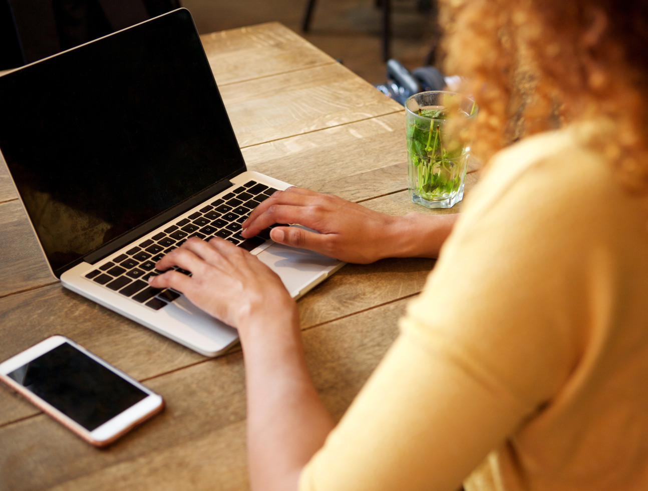 A woman typing on a computer