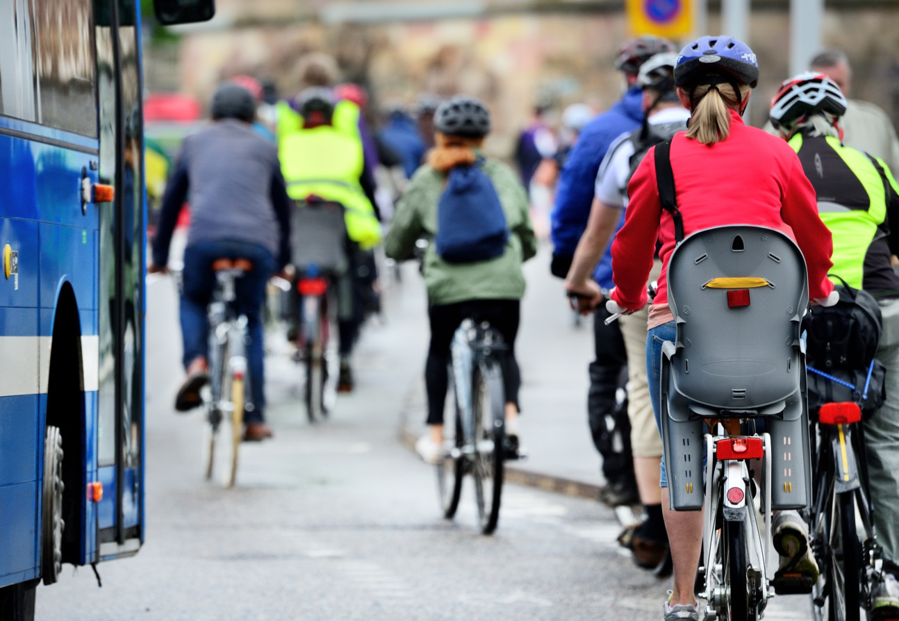 Cyclists next to a bus