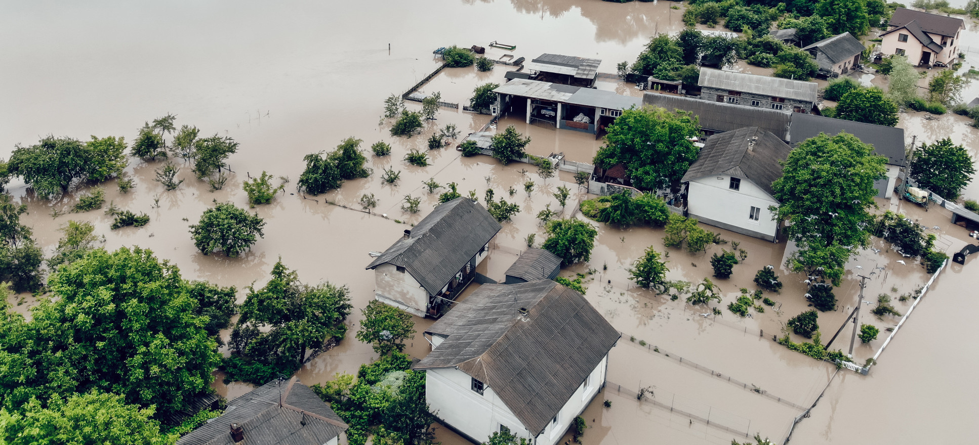 Photo showing a flooded town with houses and roads under water, taken from aerial view in Ukraine