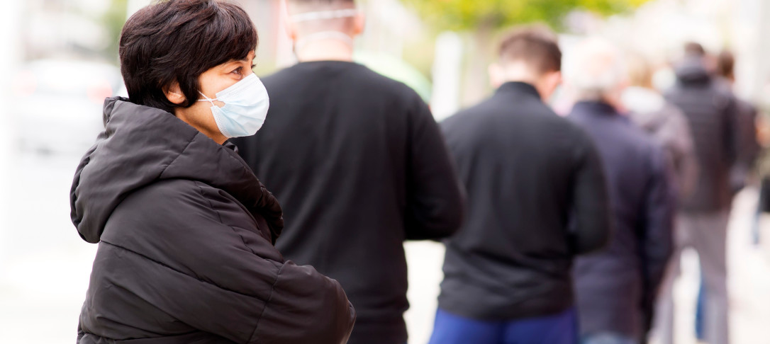 People queuing wearing masks