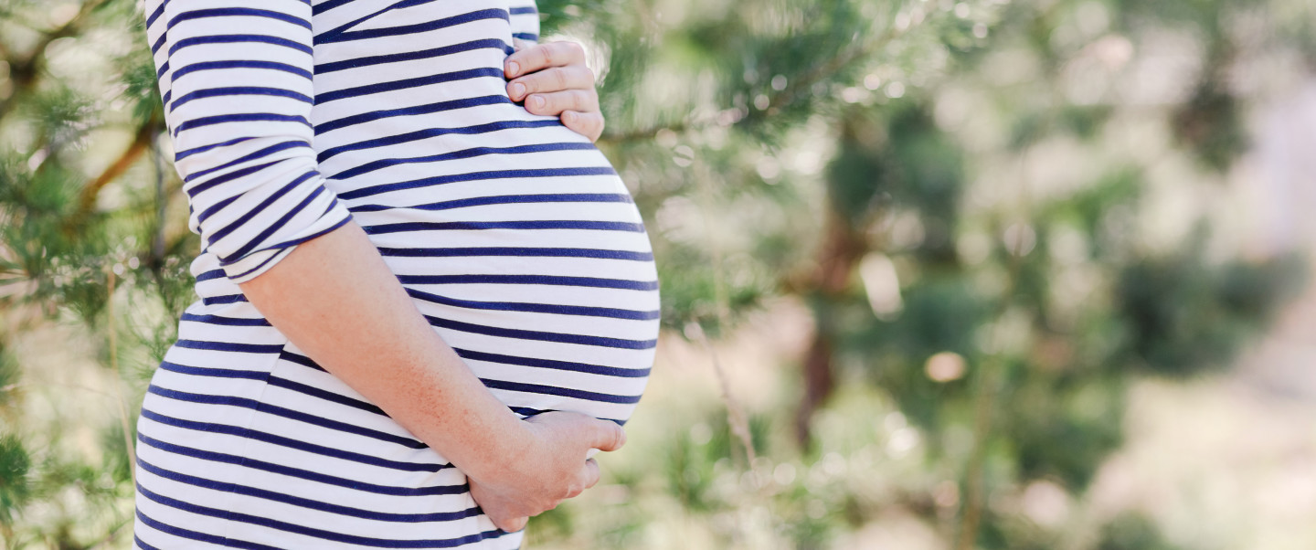 Pregnant women holds stomach