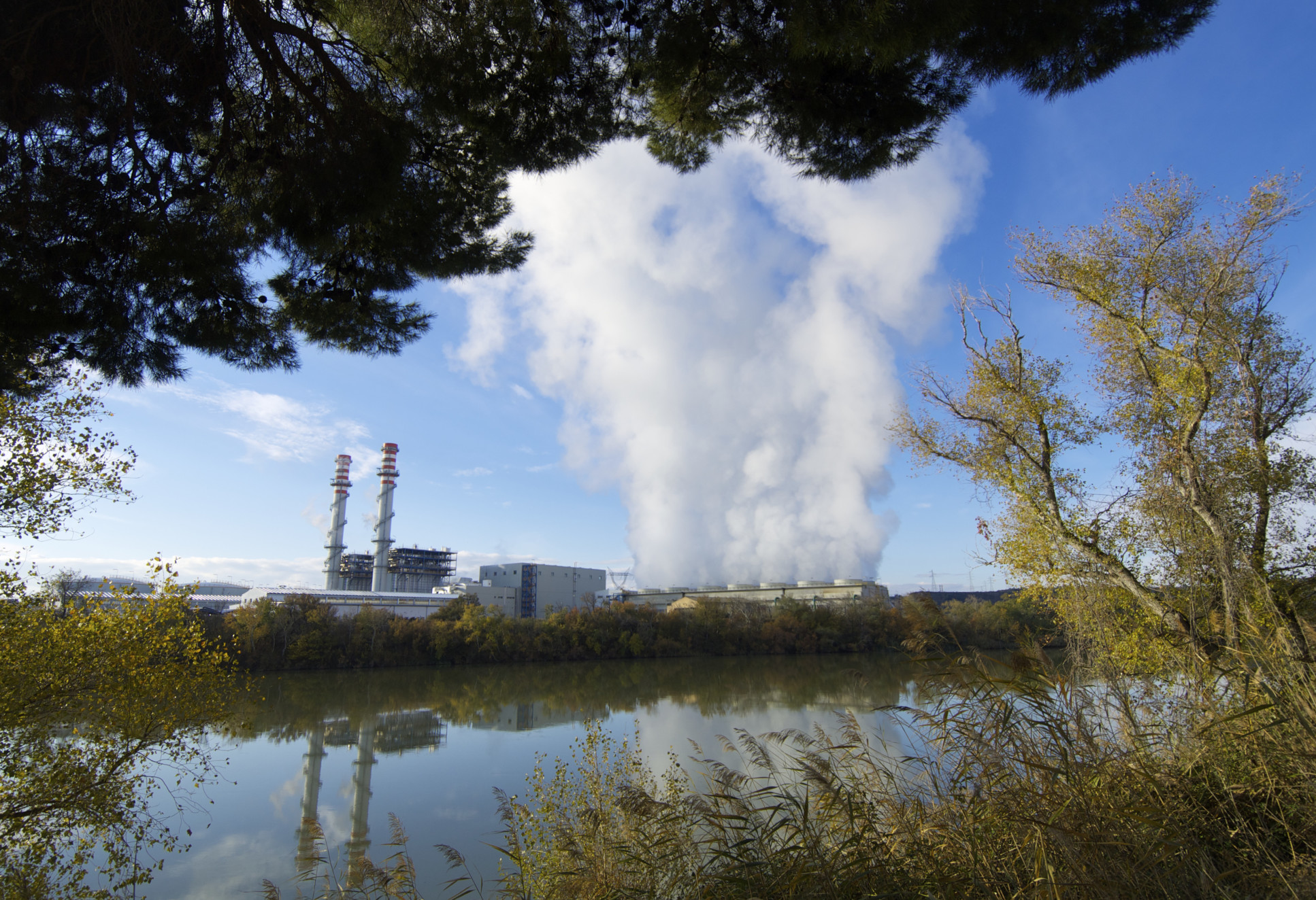 view of an electricity power station on the banks of a river