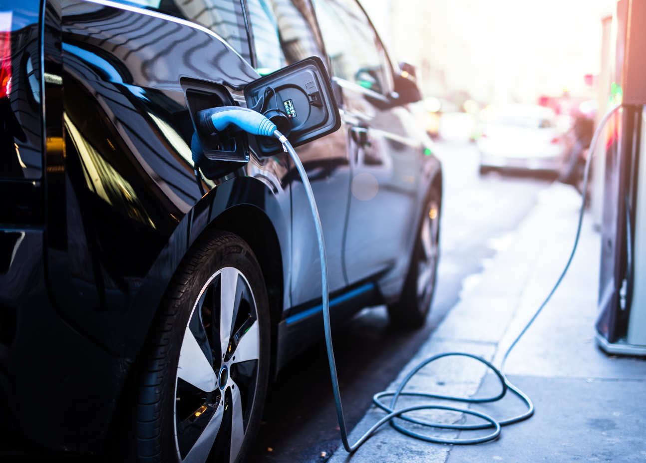 An electric car plugged in to a charging point