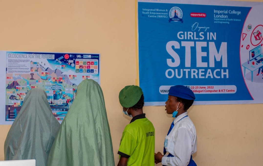 Students look at Girls in STEM and Geoscience outreach posters