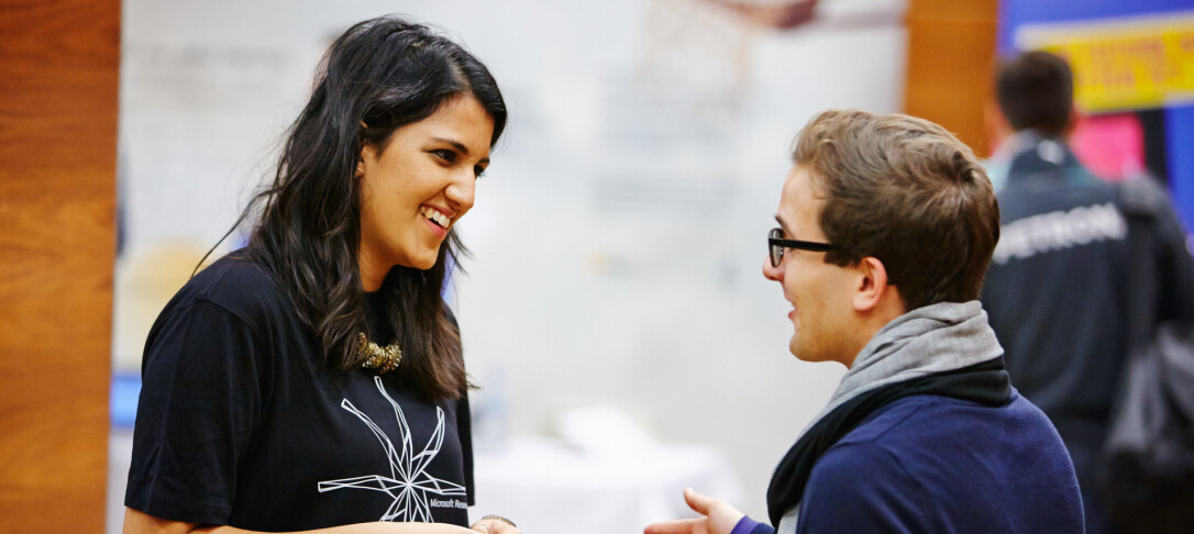Woman speaking to man at careers fair