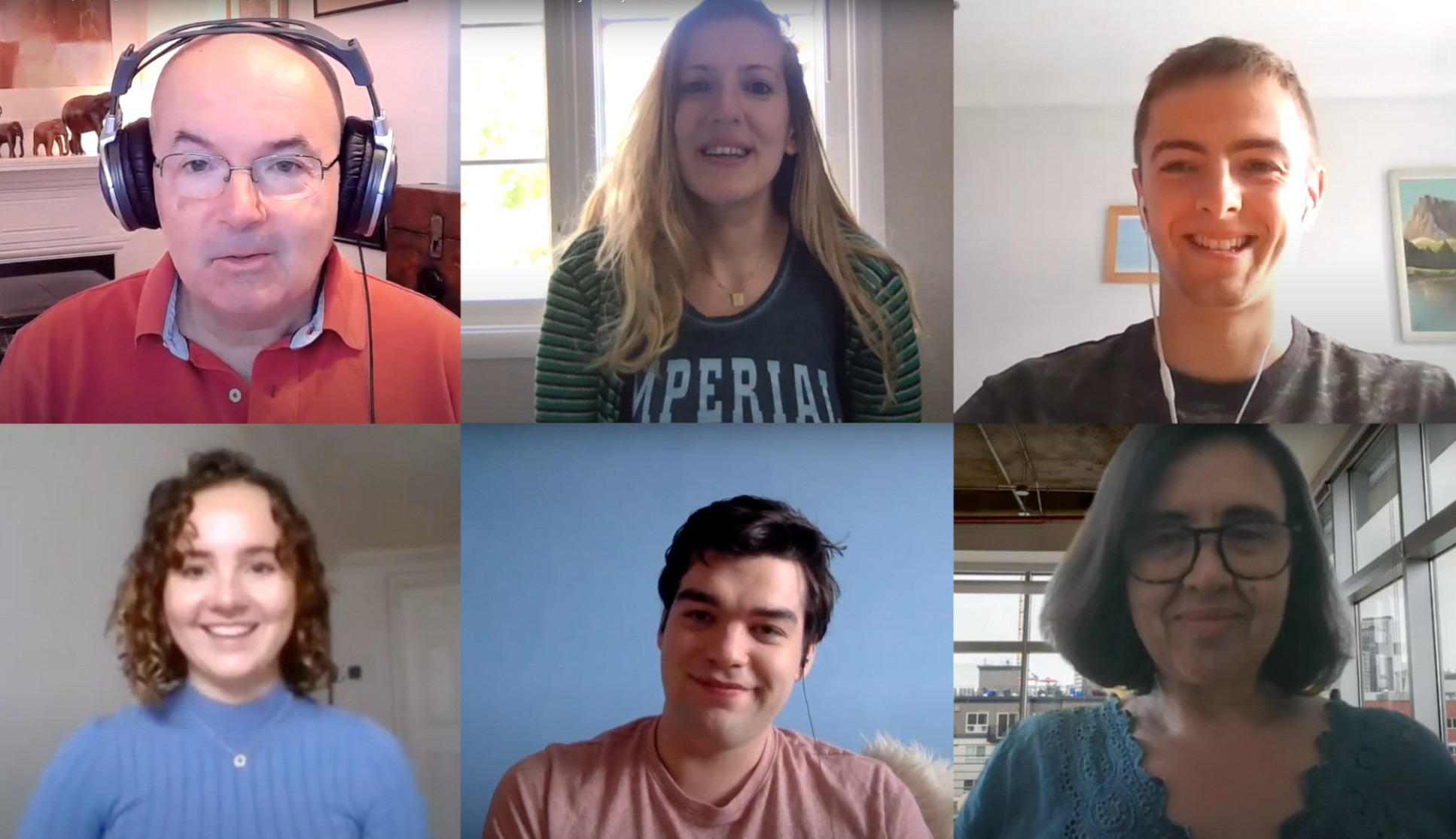 An image of six people on a video call smiling at the camera