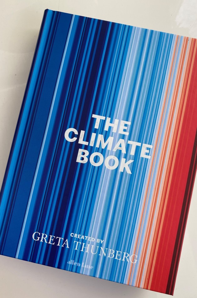 Front cover of The Climate Book, whose image is 'climate stripes' artwork by Dr Ed Hawkins