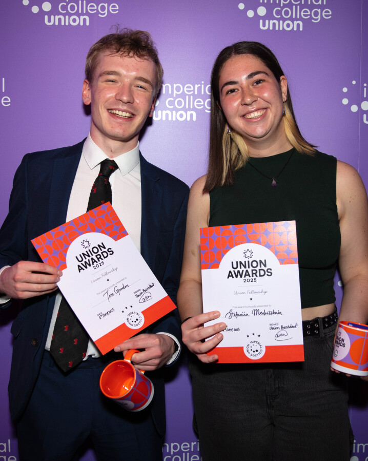Students smiling and posting with certificates after winning a Union Award