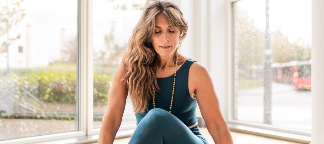 Instructor sitting on a Yoga mat