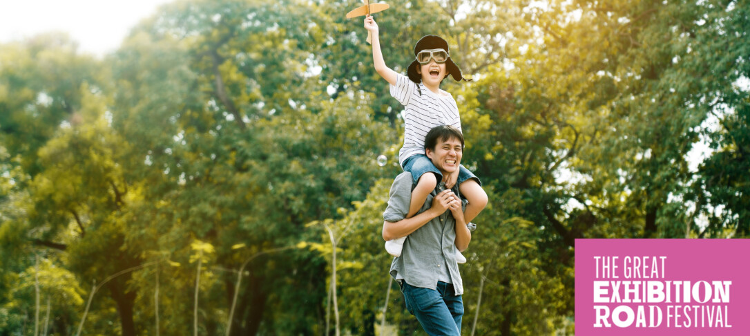 Father with child holding paper airplane