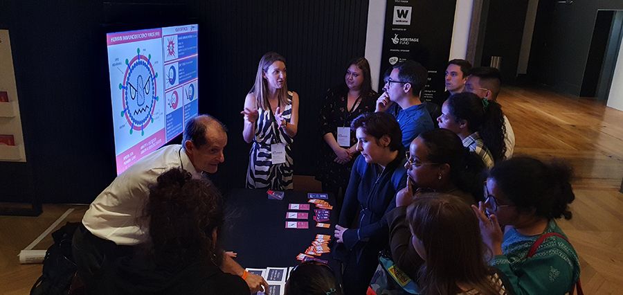 A photo of Professor Shattock and members of his team discussing HIV vaccines at the Science Museum's Pride Lates in June 2022.