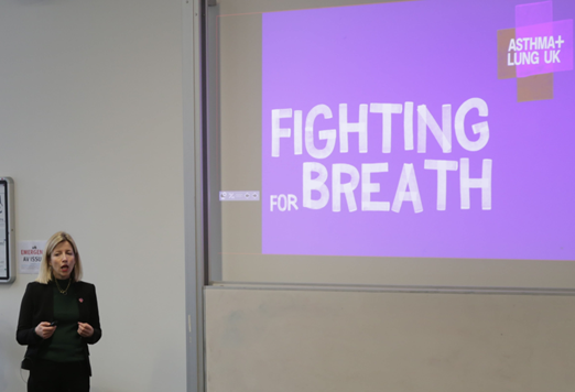 Woman in front of a presentation titled 'Fighting for breath'