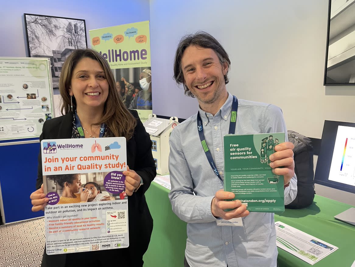 People holding flyers for the WellHome Indoor:Outdoor Air Quality study