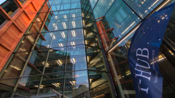 The entrance of a building with a flag saying 'I-HUB'