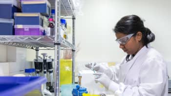 A female researcher working with chemicals in a laboratory.