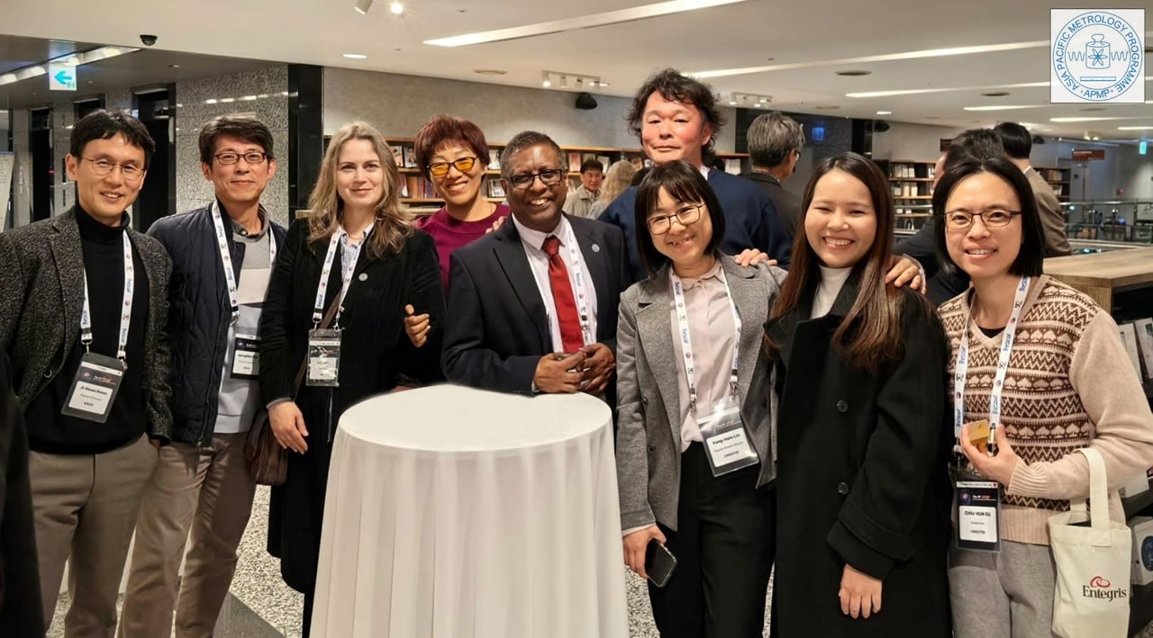 A group photo of people at a conference wearing lanyards