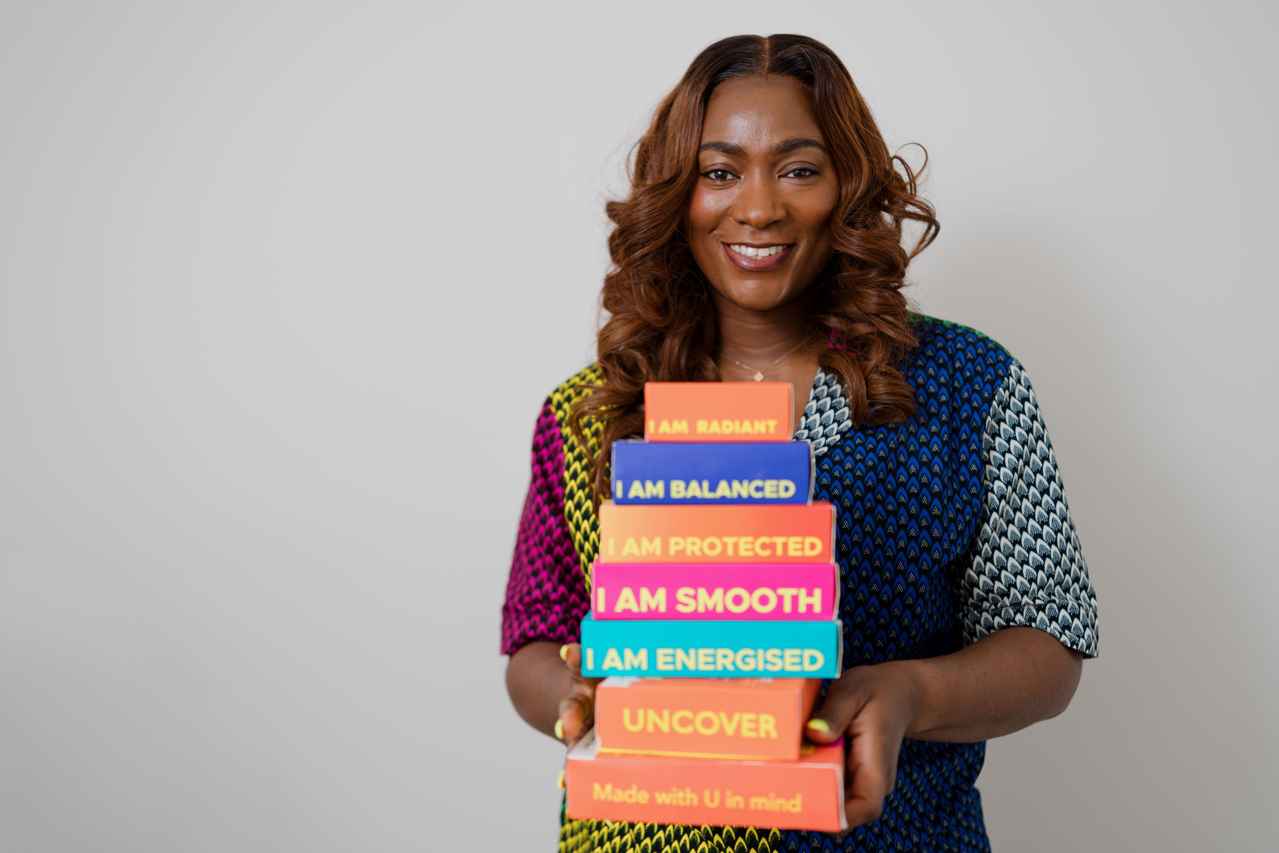 Jade Oyateru holding some Uncover products