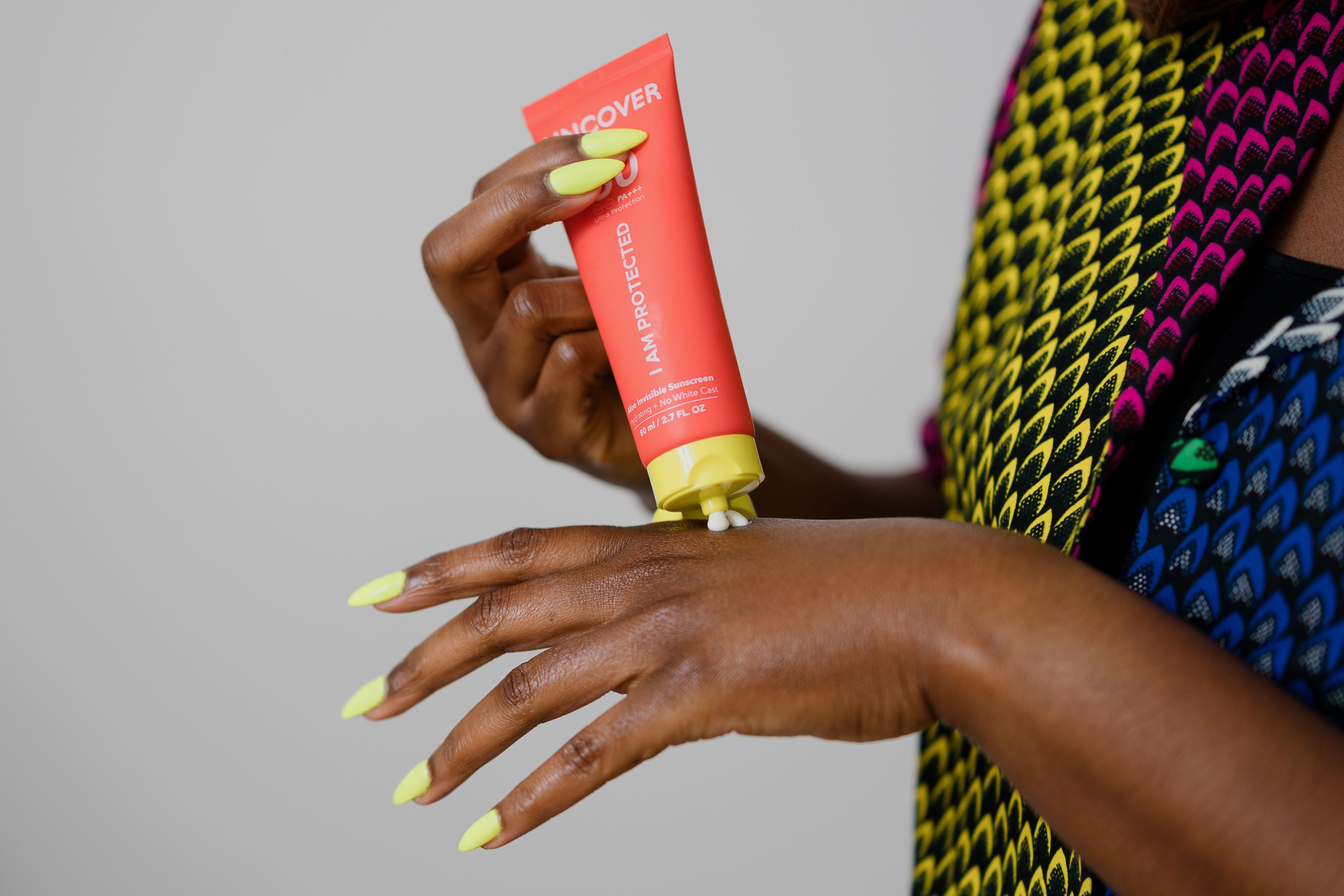 Invisible sunscreen being applied to Jade's hands