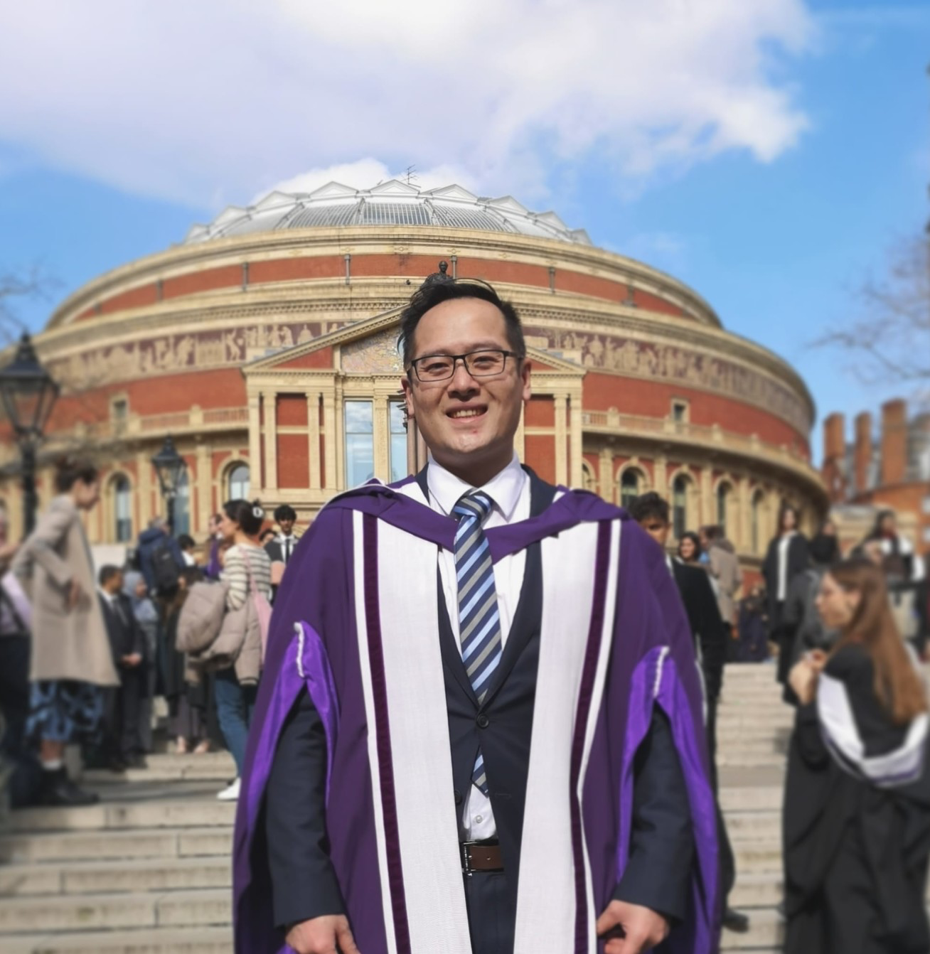 Jiajun stood outside the Royal Albert Hall in purple graduation robes