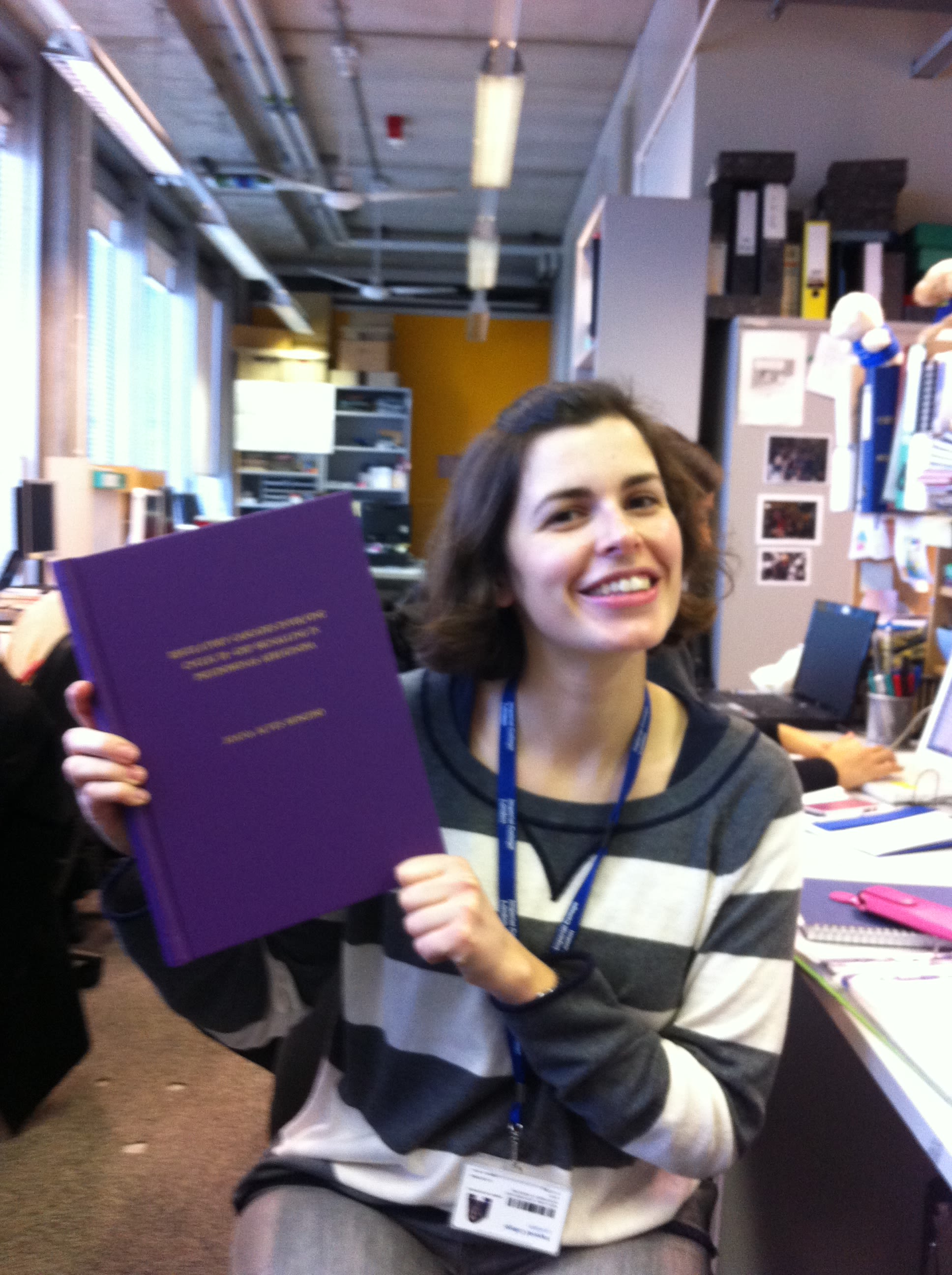 Joana holding her PhD thesis