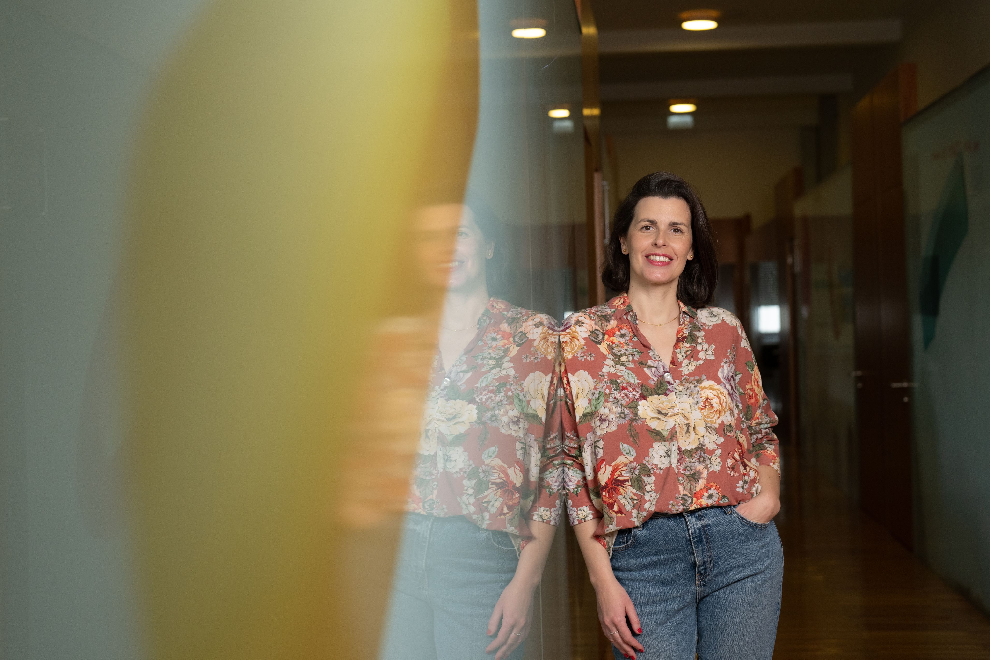 Joana Moscoso smiling wearing a floral blouse