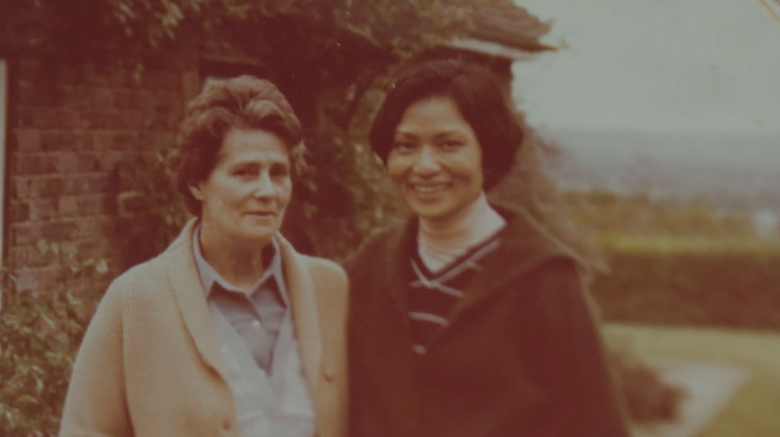 An old sepia photo of Kalaya and another woman in the English countryside