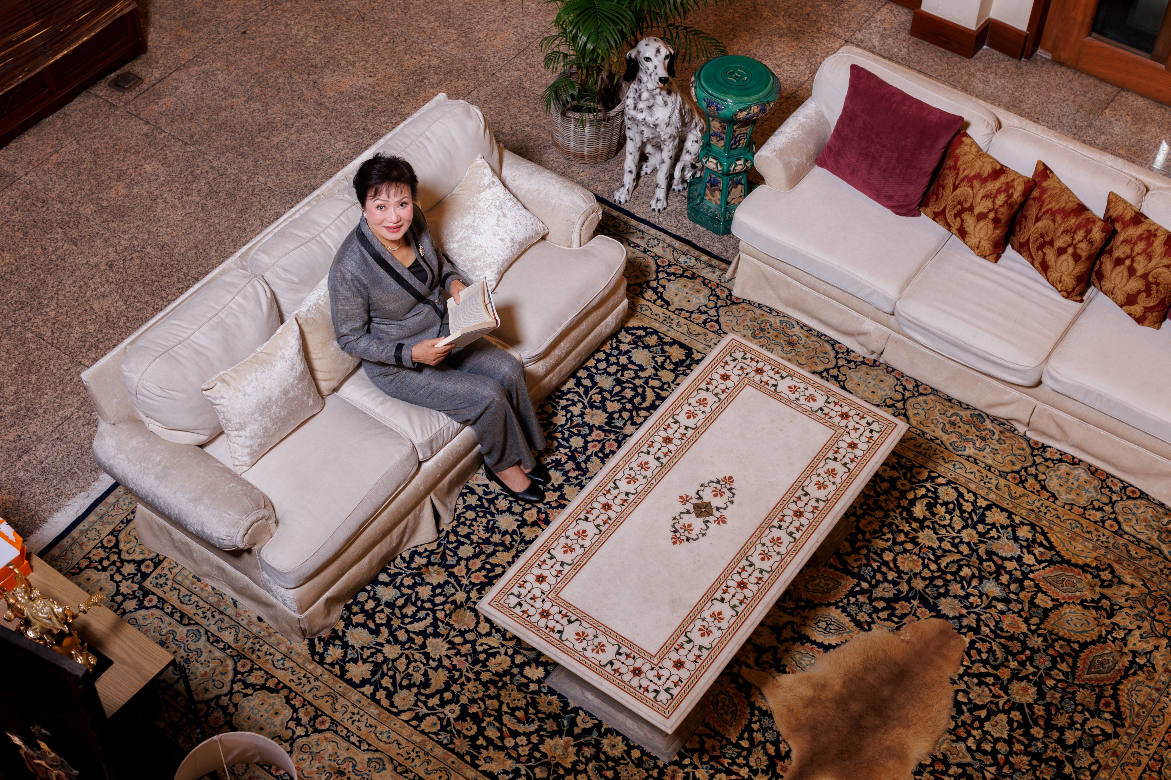 Kalaya Sophonpanich sat on her sofa in her home