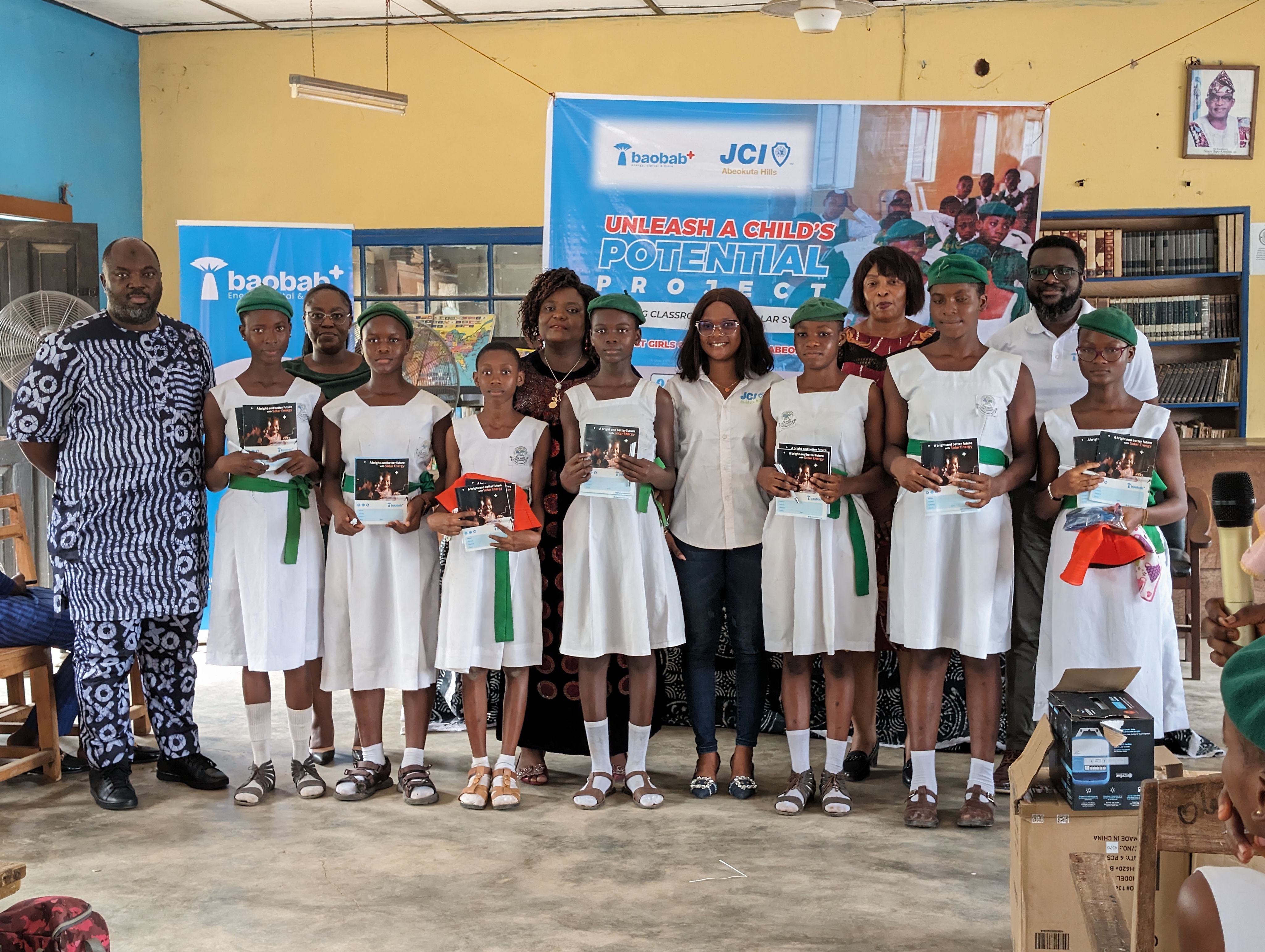 Kolawole stood in a school with pupils